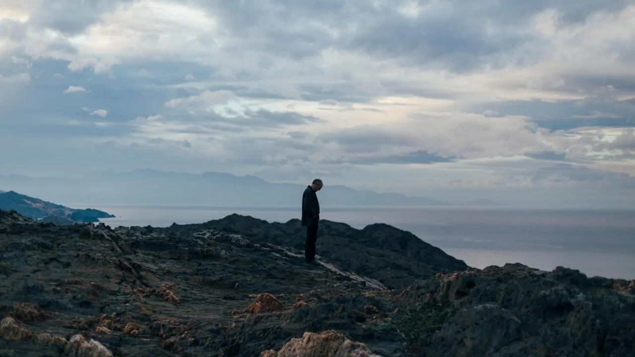 Close up on a plate of mashed potatoes, topped with baked pork chops with cream of mushroom soup, and a side of green beans.