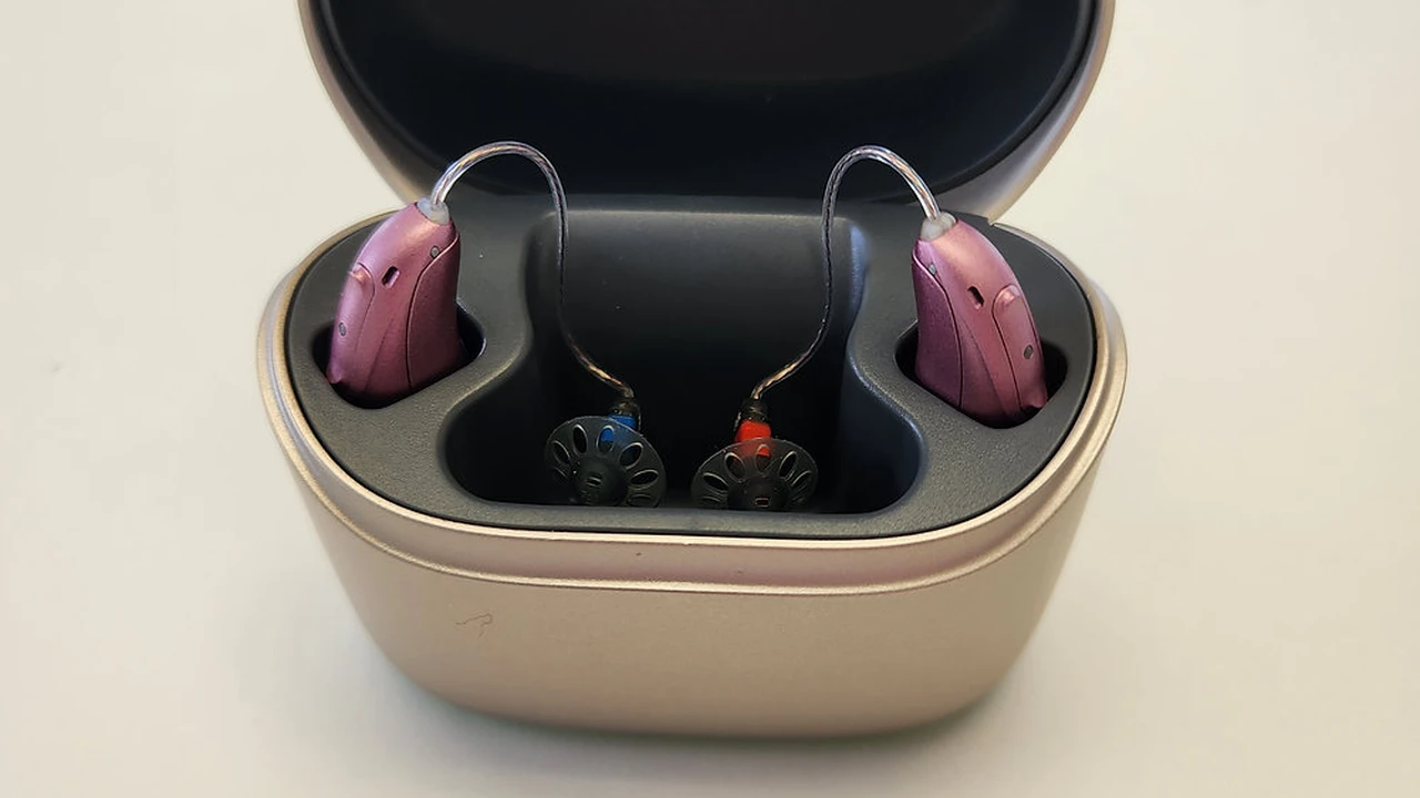Close up on a plate of mashed potatoes, topped with baked pork chops with cream of mushroom soup, and a side of green beans.