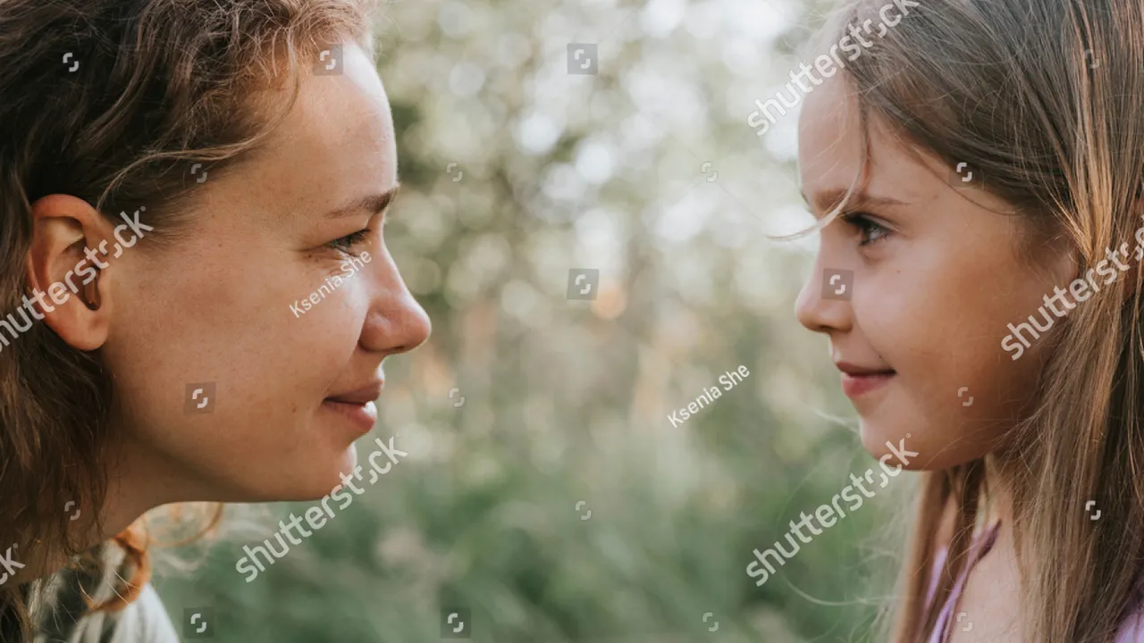 Close up on a plate of mashed potatoes, topped with baked pork chops with cream of mushroom soup, and a side of green beans.