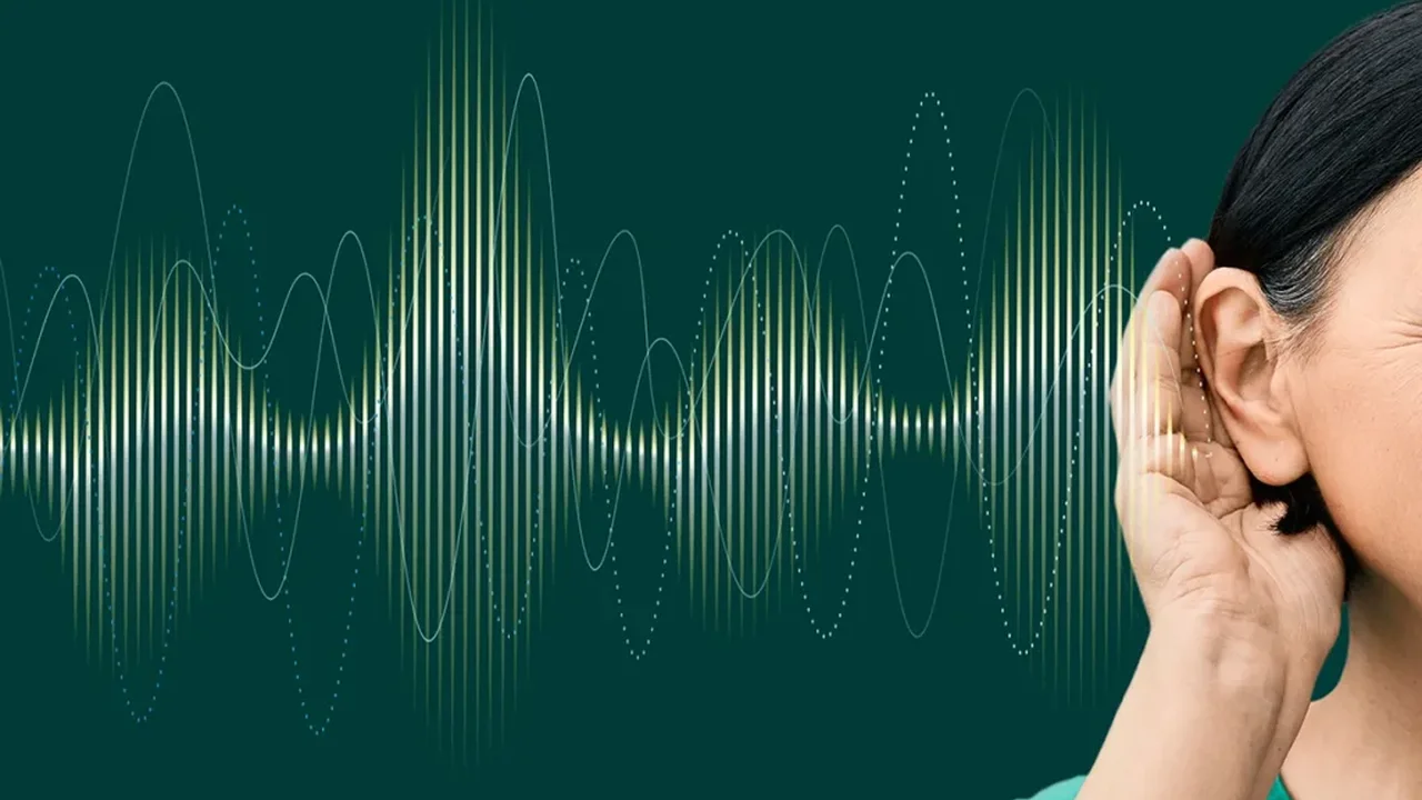 Close up on a plate of mashed potatoes, topped with baked pork chops with cream of mushroom soup, and a side of green beans.