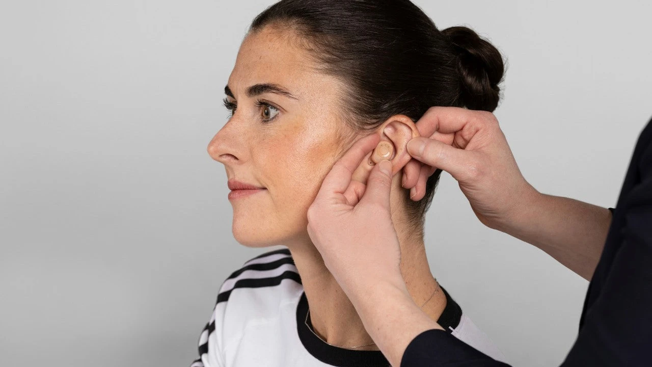 Close up on a plate of mashed potatoes, topped with baked pork chops with cream of mushroom soup, and a side of green beans.